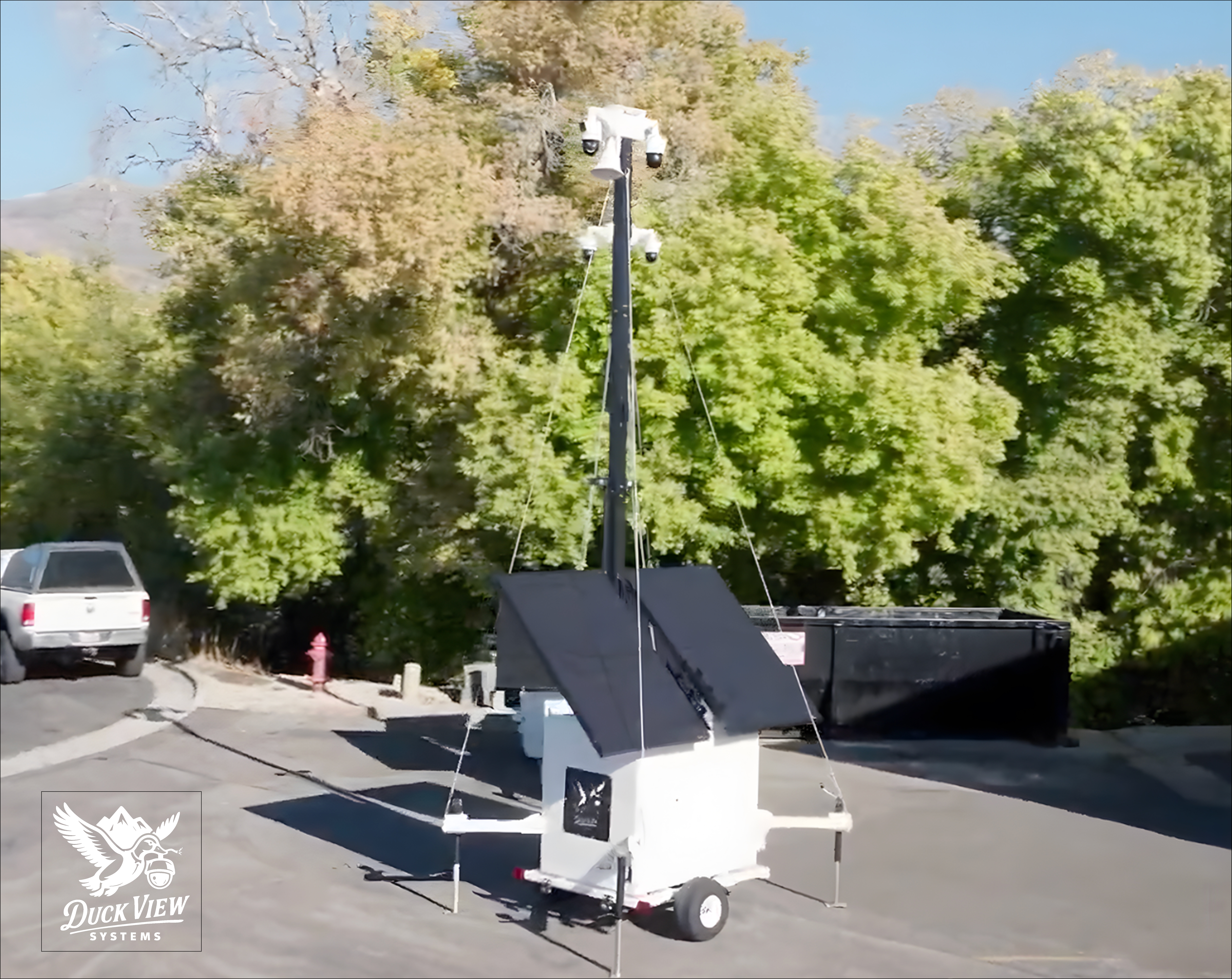 Mobile Remote Asset Monitoring Unit on Site Remote asset monitoring tower with elevated cameras and solar panels deployed outdoors, providing real-time visibility and active protection for assets and job sites