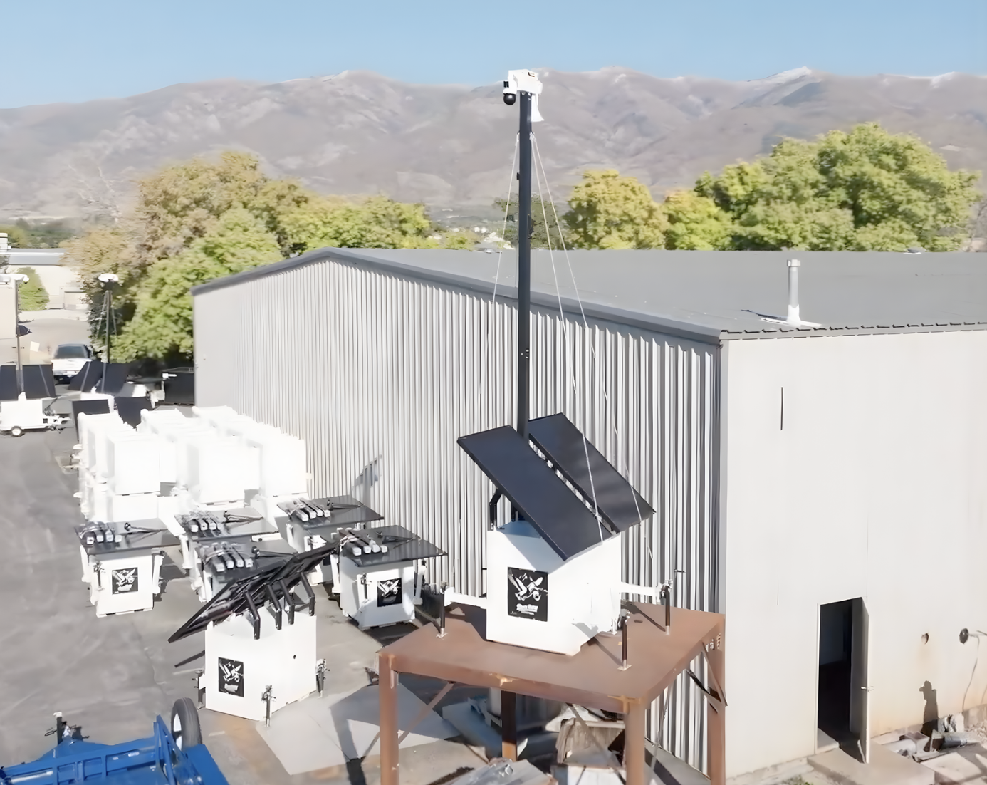 Mobile Camera Trailer With Solar Power at Industrial Site Mobile camera trailer with elevated mast and solar panels installed at an industrial facility, providing autonomous surveillance coverage for large outdoor areas with off-grid power.